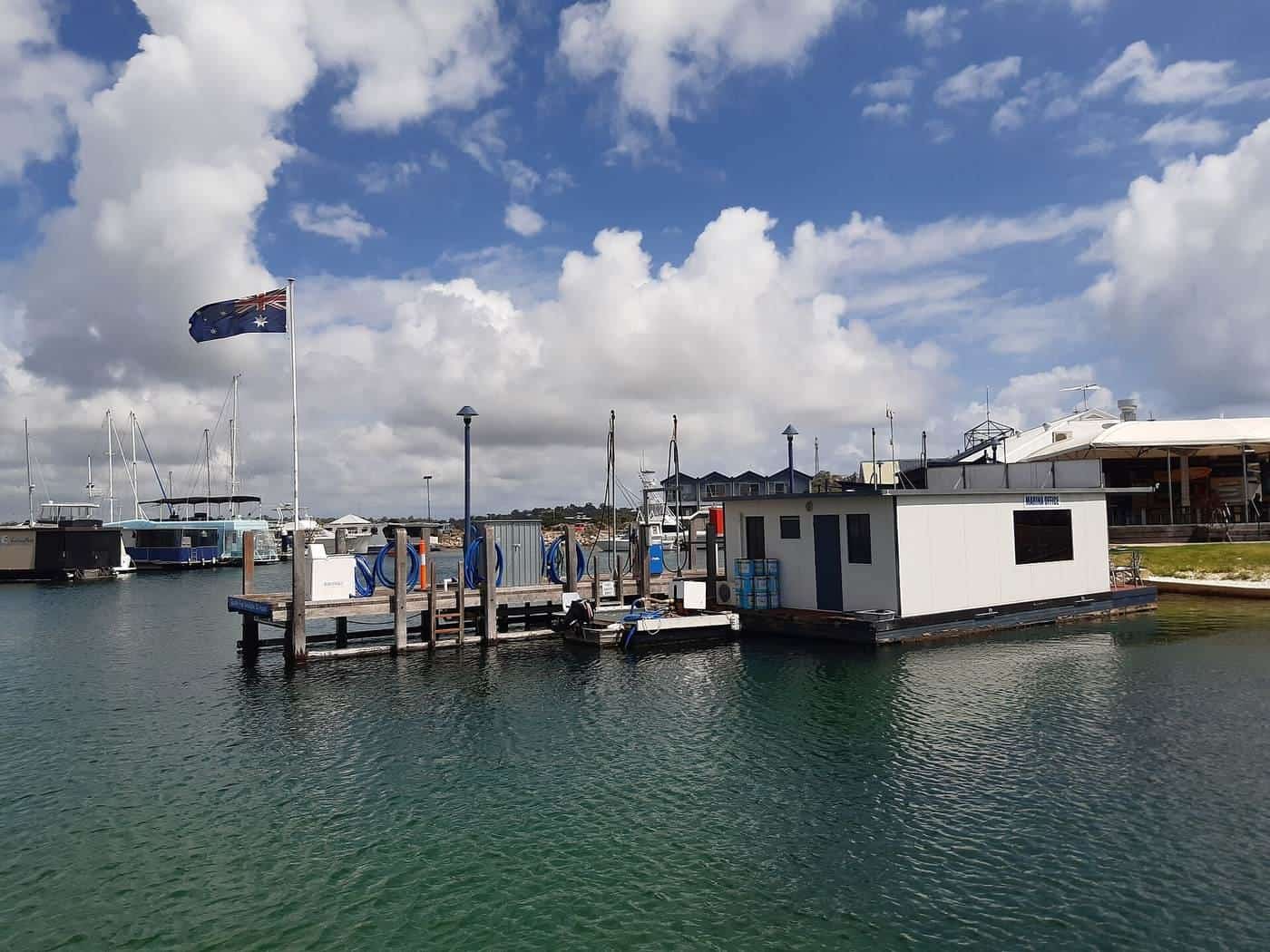 A fuel jetty with pumps at the end of a marina pontoon